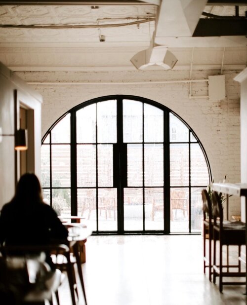 Oversized windows lead to a small outdoor area at the back of Harless + Hugh. (Photo courtesy of Harless + Hugh Coffee)