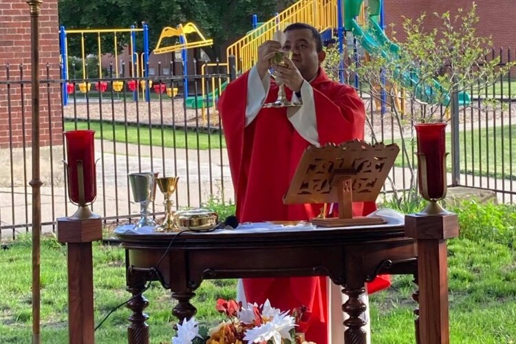 The Rev. José Mariá Cabrera, Pastor of All Saints Parish. celebrates Mass near the entrance to the Adoration Chapel. (Photo courtesy of All Saints Parish.)