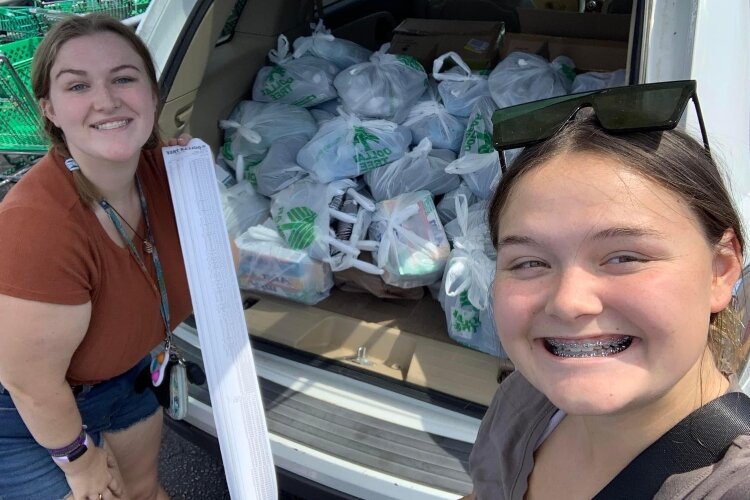 Wrzesinski, at left, and Maya Linkowski, a Bay City Central High School senior, pose with some of the supplies they collected for the hygiene bags. (Photo courtesy of Grace Wrzesinski)