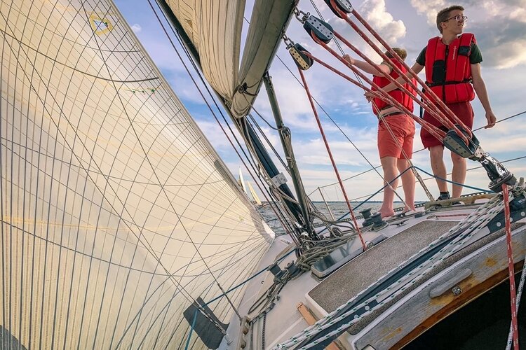 The Wampum crew sailing to weather in a Main & Jib race.