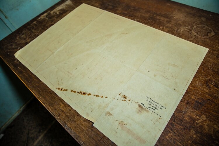 While the inside is mostly empty – except for heavy pipes and pumps – there are a few paper records scattered on desks inside the building.