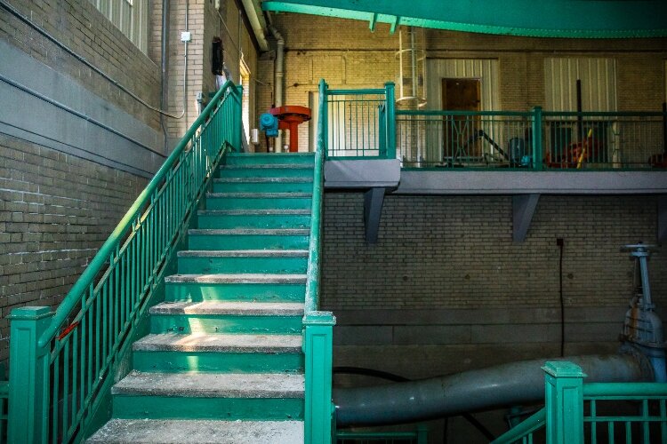 The interior is primarily a large, open space, but stairs lead to second-story floors overlooking the main room.