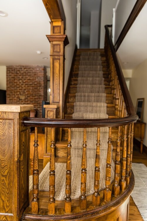 The main staircase was sanded, stained, and restored to its original status as a grand staircase. (Photo by Ashley Brown)