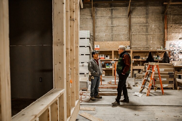 General Housing Corp. VIce President Kevin Light talks to one of the skilled laborers inside the Bay City factory.