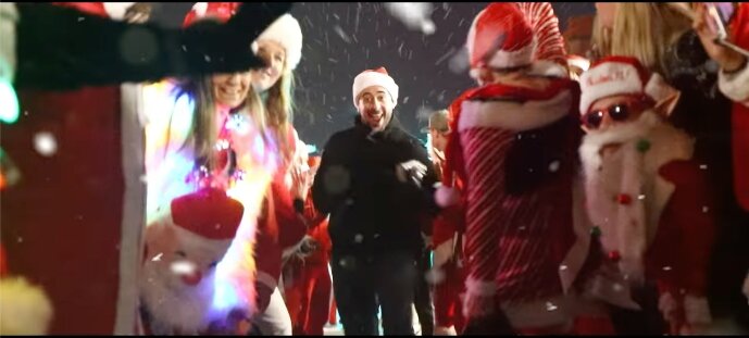 In the newest version of 'The Gift,' Trombley runs through a crowd of Santas.