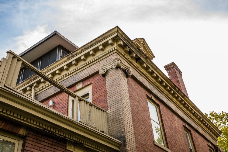 The cornice’s dental moldings give the home a striking appearance.