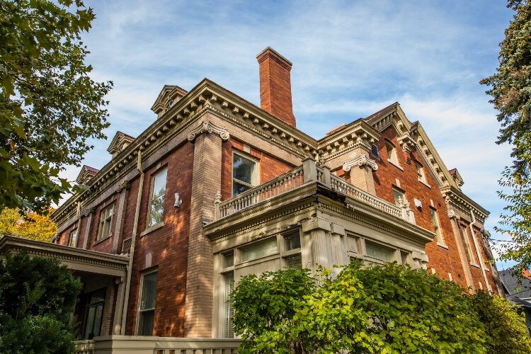 Limestone scrolls top the brick columns on the corners of the Tupper home.