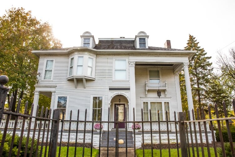 The home’s front porch stretches two stories tall.