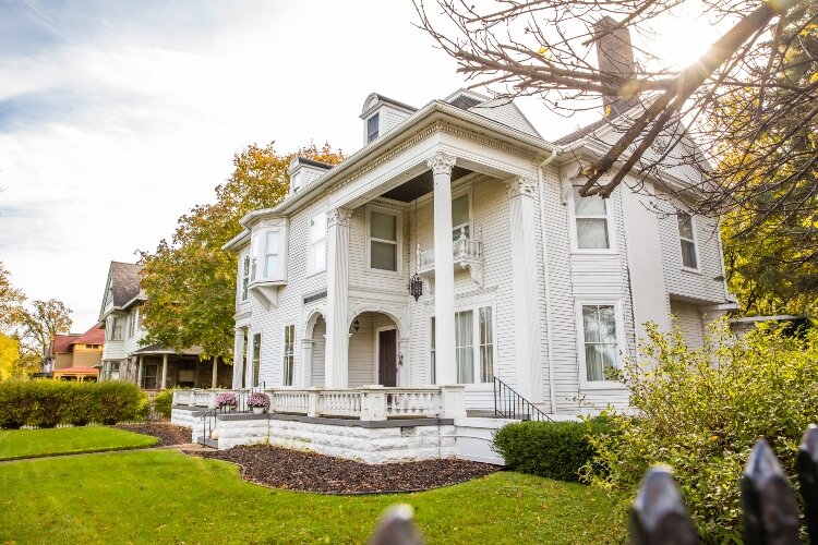 The porch features Corinthian columns.