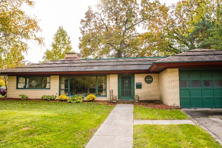 The home’s interior includes many built-in features such as heating flooring. In the back, a sunroom overlooks a courtyard and built-in barbecue.