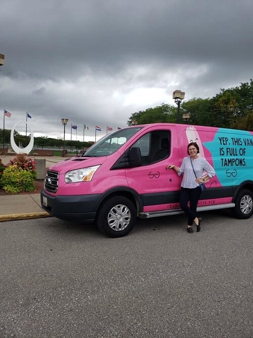 Moira Branigan of the YWCA poses with the van when it stopped here.