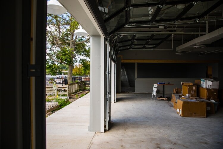 The glass roll-up overhead doors line the wall facing the river.