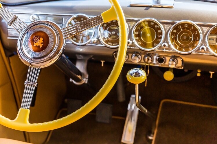 Features include cigarette lighters and ashtrays on each side of the interior, and a cigar lighter in the dashboard. 