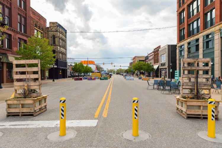 Bright yellow markers prevent vehicles from traveling on several streets, leaving them open for outdoor summer events.