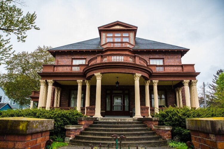 The home was built in the Four-Square style, which usually means little ornamentation. However, this home features fluted columns and a curved portico.