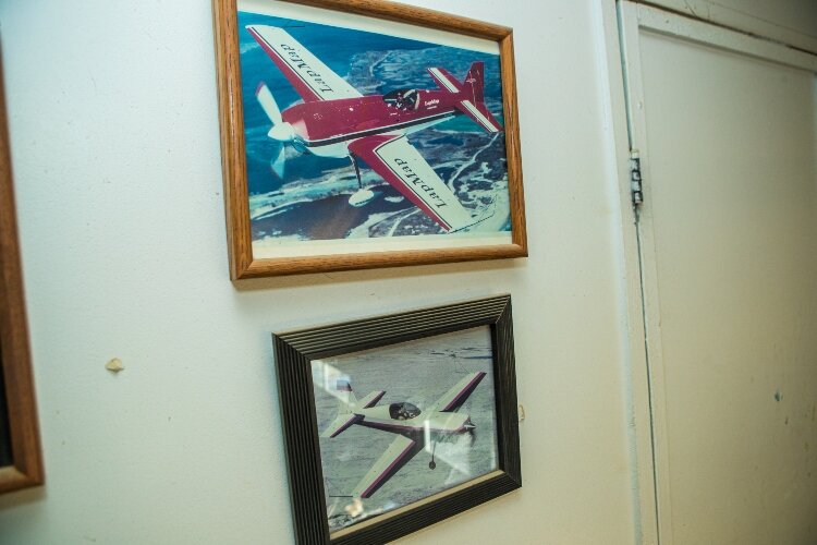 Trophies, plaques, and photos of Staudacher's work fill a wall of the workshop.