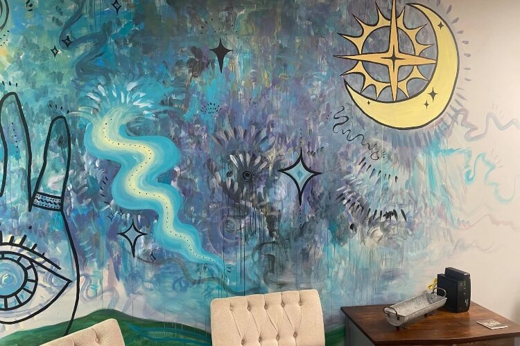 A mural covers one wall of the business, which offers healings, massages, chakra balancing, tarot readings, angel readings, and more.
