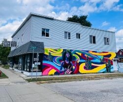 One mural adorns the wall at Unclaimed Freight Ace Hardware, 706 E. Midland St.