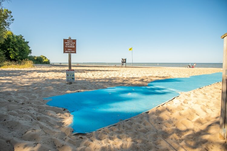 A bright blue mat makes it easier for wheelchairs to cross from the sand to the water at the Bay City State Park.