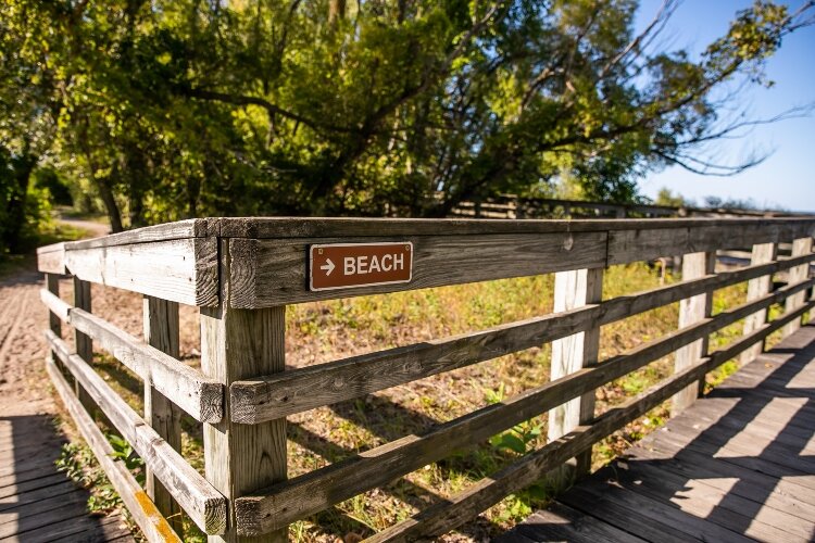 Boardwalks lead visitors from the parking lot and playground area to a sandy beach bordering the Saginaw Bay.
