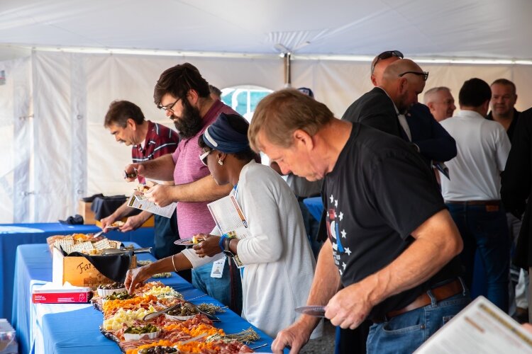 The farmers, business leaders, politicians, and others who joined the ribbon-cutting ceremony were treated to food from Prost! and Michigan Cream and Sugar Ice Cream Company.