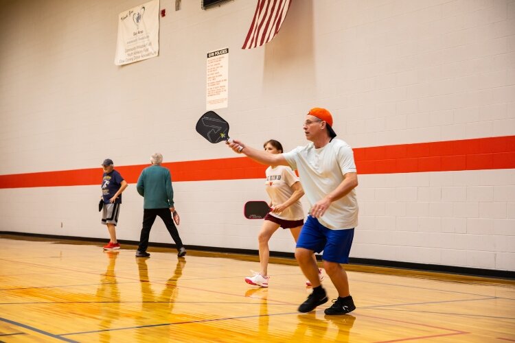 The three courts at the Bay County Community Center are busy six days a week. Here, Jeff Lynch and Michelle Kulas play on one court while Ross Jones and Don Walsh play on a different court.