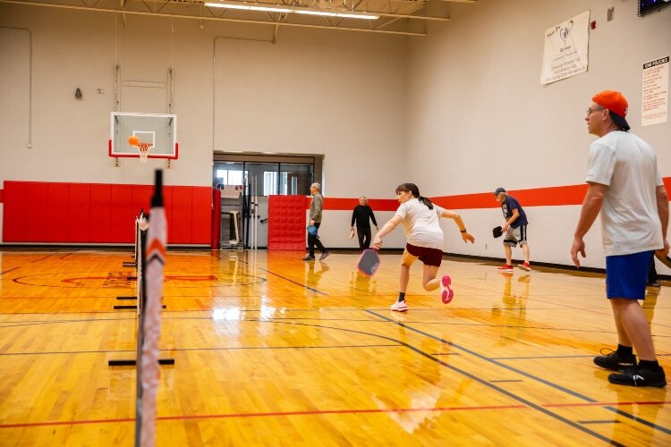 Jeff Lynch waits as Michelle Kulas hits the ball during pickleball league play at the Bay County Community Center.