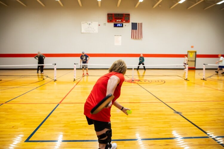 Ann Lynch serves the ball.