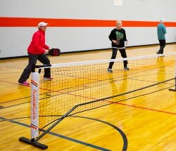 Pickleball is about social interaction and fitness as much as it is about competitiveness. On a recent weekday, players filled the Bay County Community Center. From left, Sue Anderson, Ashley Anderson, Barb Thayer, and Vern Botts.