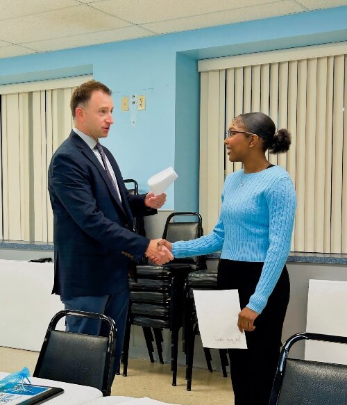 Zaid shakes hands with Board President Ty Mier. (Photo courtesy of the Boys & Girls Clubs of the Great Lakes Bay Region)