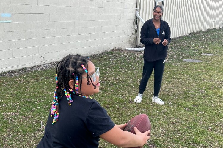 Zaid throws a football with a Club member. (Photo courtesy of the Boys & Girls Clubs of the Great Lakes Bay Region)