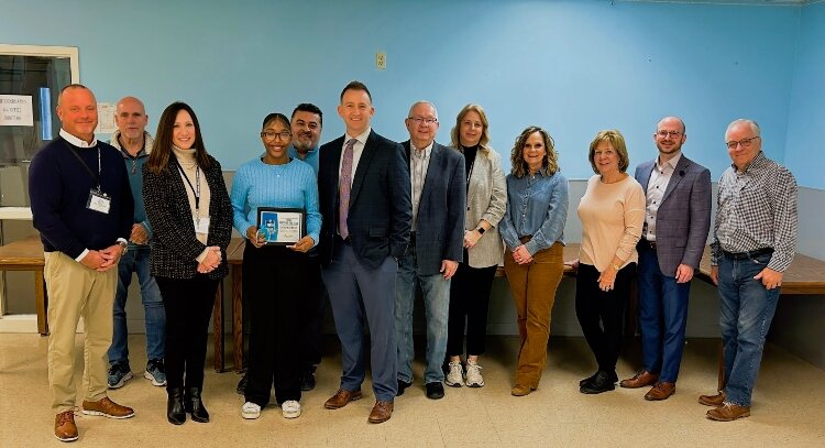 Zaid poses with the board of the Boys & Girls Clubs. Club members embrace Jackson when they learn she has been named Youth of the Year.