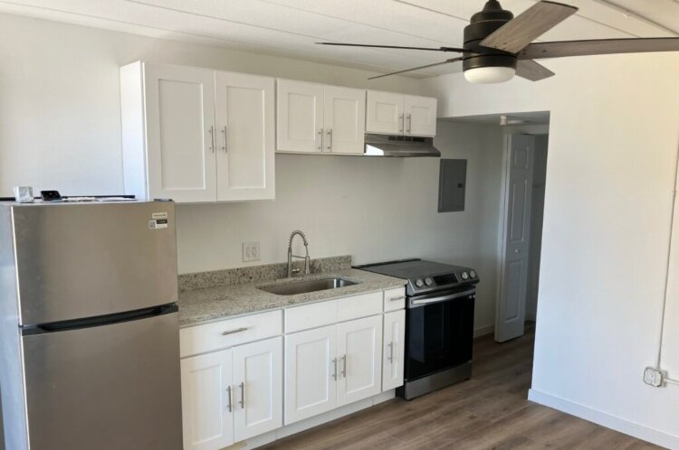 The motel rooms were renovated to include granite counters, shaker cabinets, and new appliances.