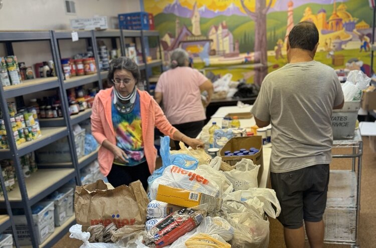 Amy Rajewski and other volunteers sort donations at St. Boniface Church (All Saints Parish).