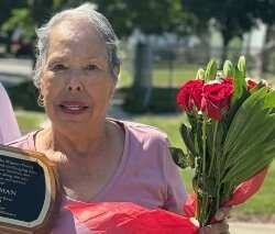 Irma Guzman poses for a photo in 2024 after receiving an award for 16 years of dedication and service.