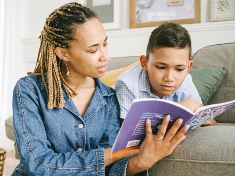 Woman and a Boy Reading Book Together